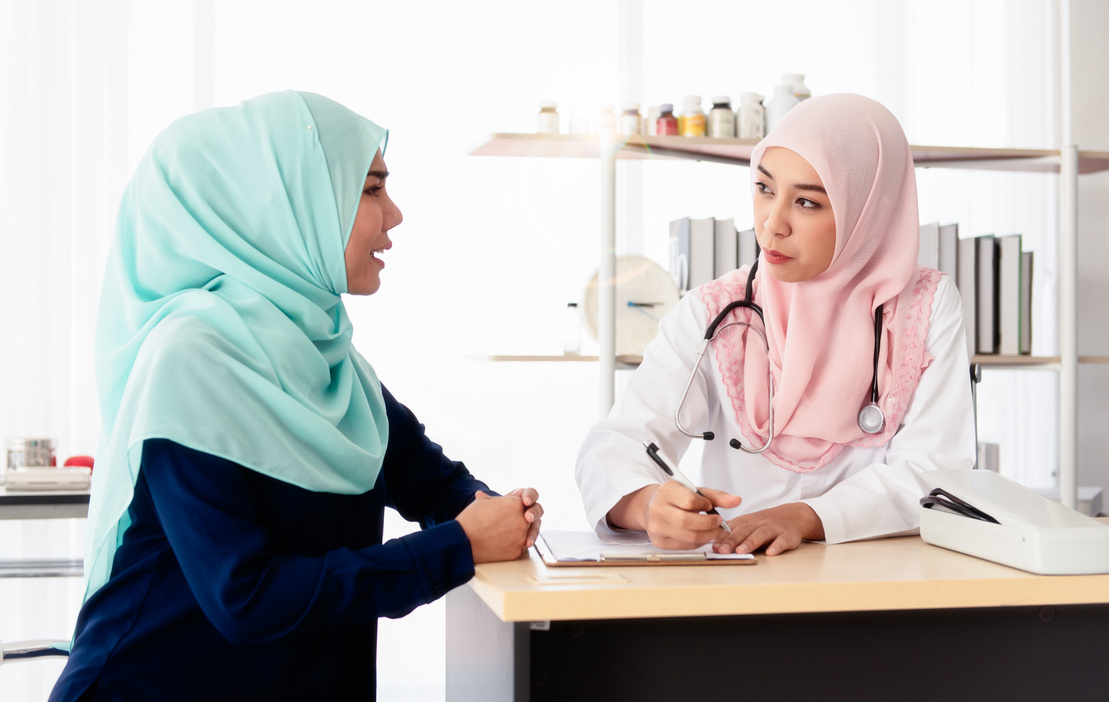 A Muslim doctor asking the patient's illness.